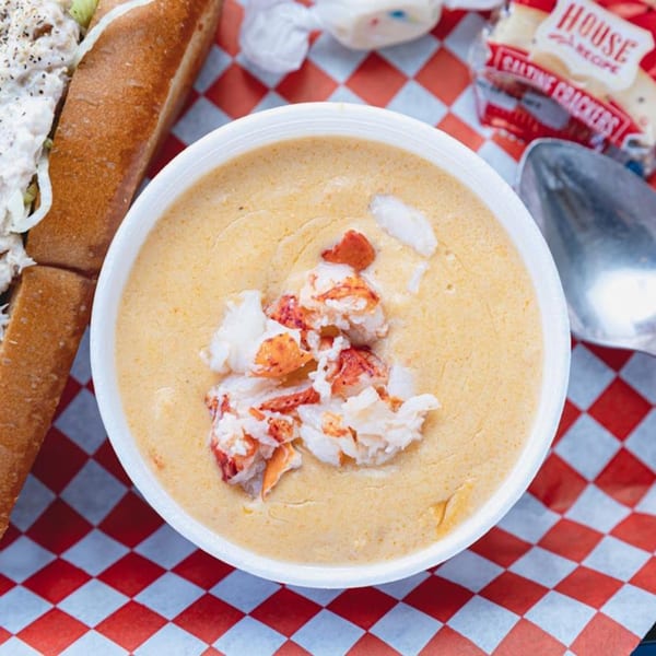 A Maine-ly Sandwiches lobster bisque with chunks of lobster, a lobster roll, and crackers.